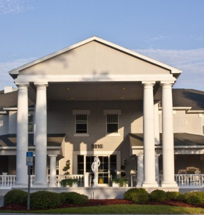 The front of a large building with columns.